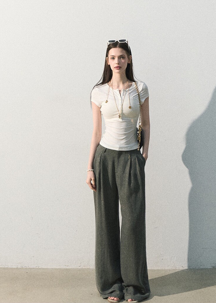 White fitted button-neck tee styled with wide-leg trousers