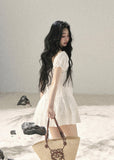 White puff-sleeve mini dress with square neckline