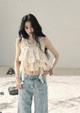 Ivory layered ruffle sleeveless top with cascading chiffon details