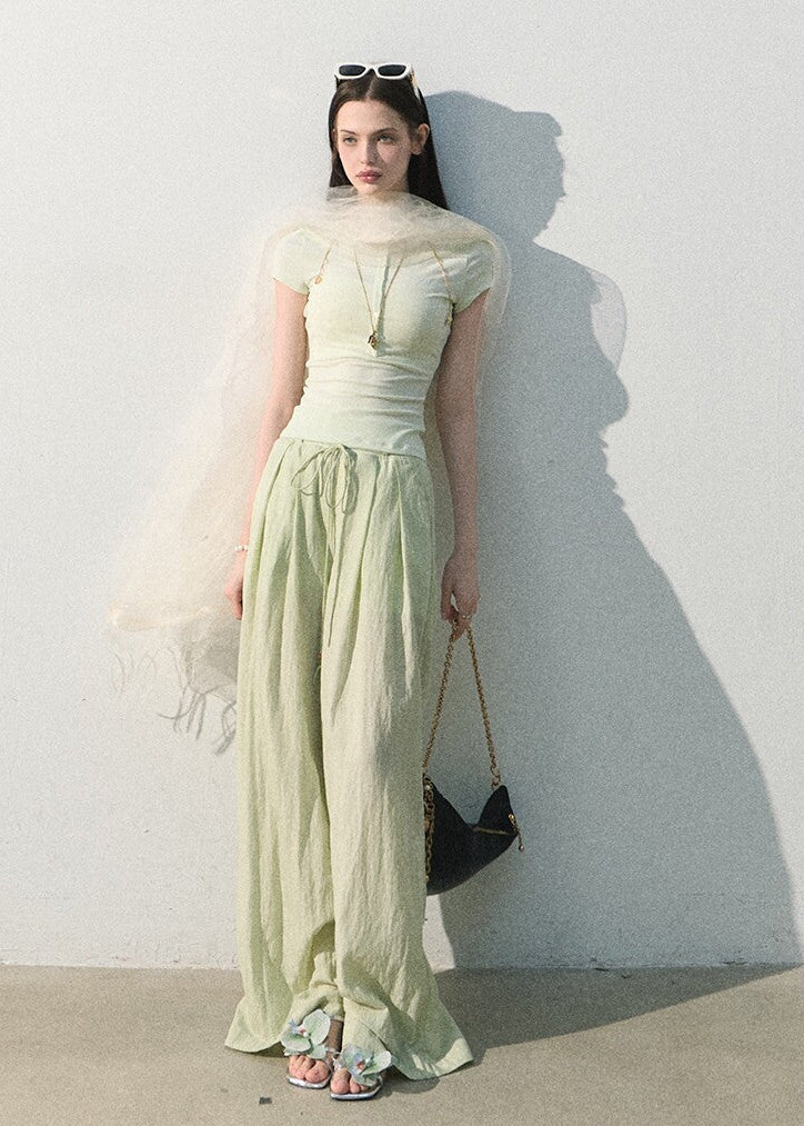 Mint green stretch-knit tee styled with relaxed trousers