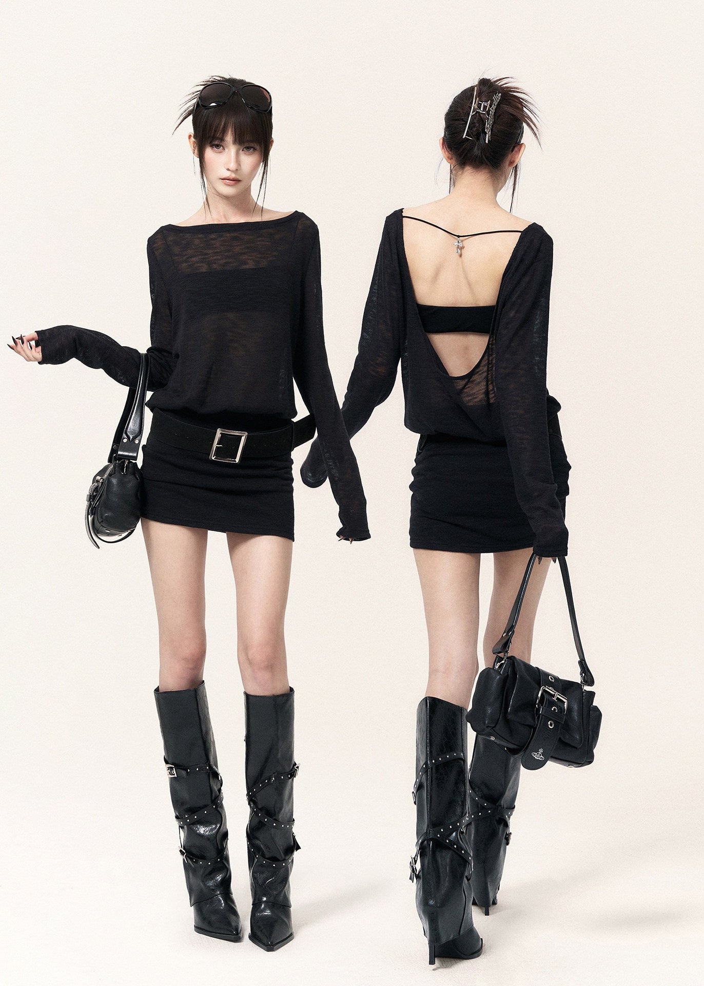 Back view of a black open-back dress with cross straps and a metal pendant
