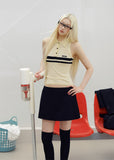 Black low-rise A-line mini skirt styled with an ivory lace camisole