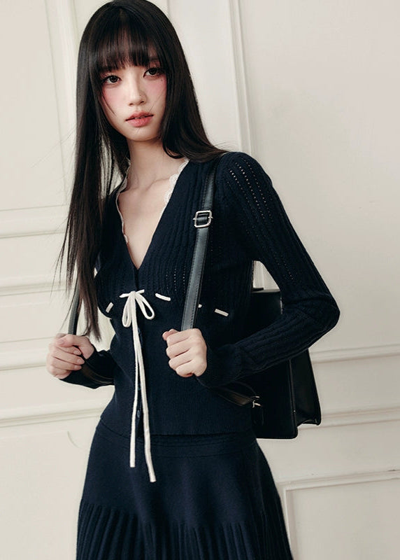 Fragileheart knit skirt set, black pleated two-piece, luxury Korean fashion, elegant autumn outfit, quiet luxury womenswear, pastel noir aesthetic, V-neck cardigan set, modern feminine K-fashion, minimalist ribbed knit, poetic fashion 2025, romantic fall outfit, delicate Korean style, sophisticated knitwear set, graceful pleated skirt look
