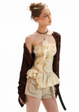 Strapless ruffle top styled with boots and a shoulder bag