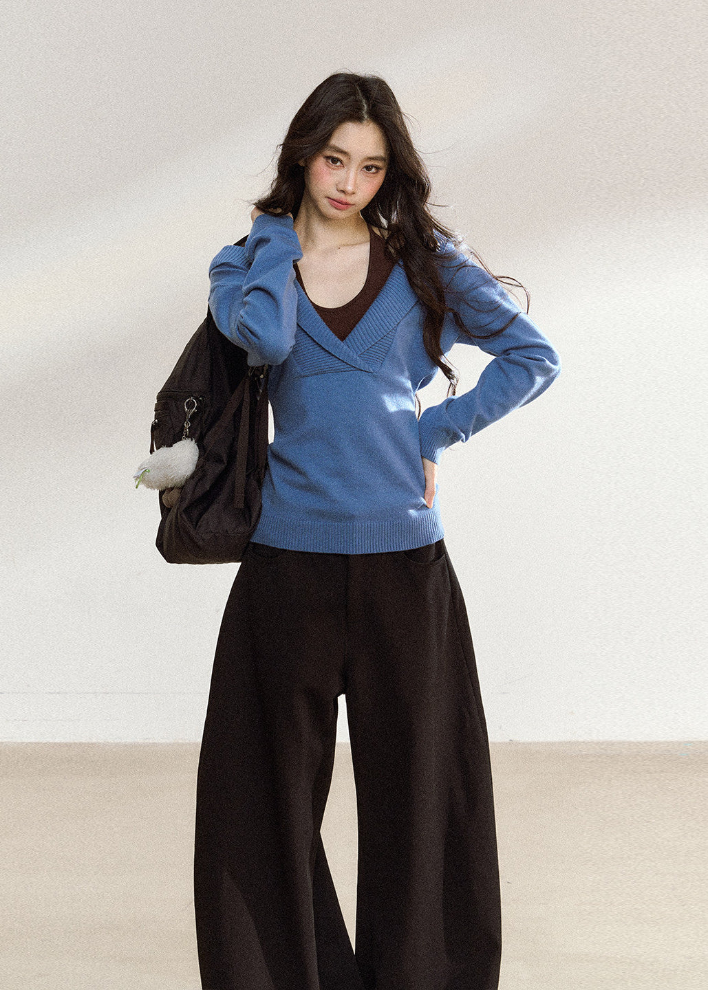 Blue asymmetric knit top with a wide foldover neckline