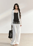 White draped cardigan with a charcoal gathered camisole