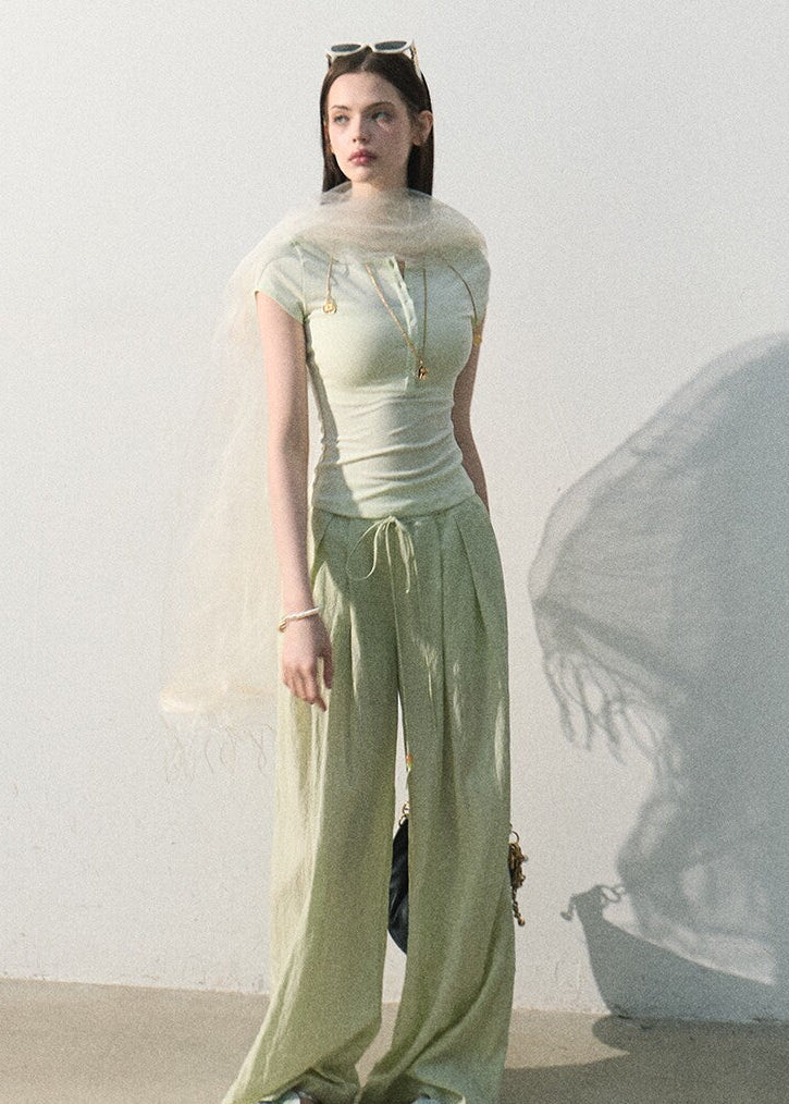 Mint green stretch-knit tee styled with relaxed trousers