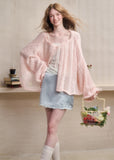 Lightweight fuzzy cardigan worn off the shoulder