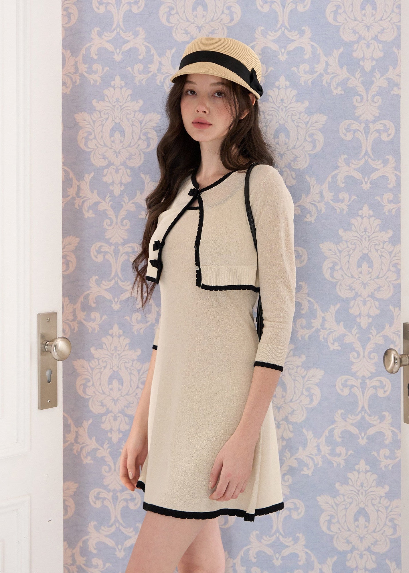 short sleeve knit cardigan, cropped knit cardigan, bow closure cardigan, asymmetric cardigan, cream knit cardigan, French style cardigan, Korean feminine cardigan, contrast trim cardigan, soft knit top, summer layering cardigan, romantic knit cardigan, feminine Korean fashion, vintage inspired cardigan, cream bow cardigan, lightweight knit cardigan