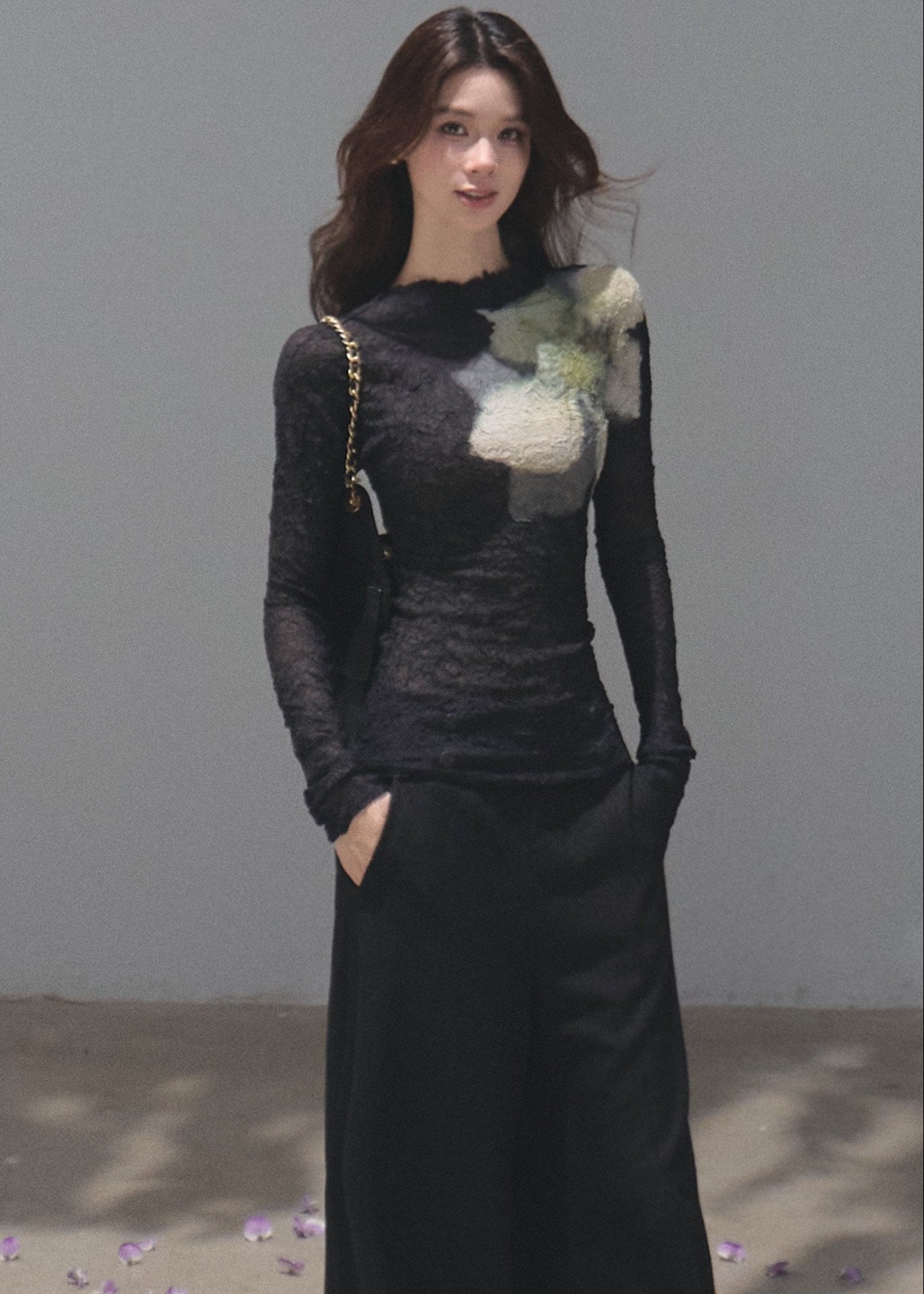Model wearing a black botanical-print long-sleeve base layer