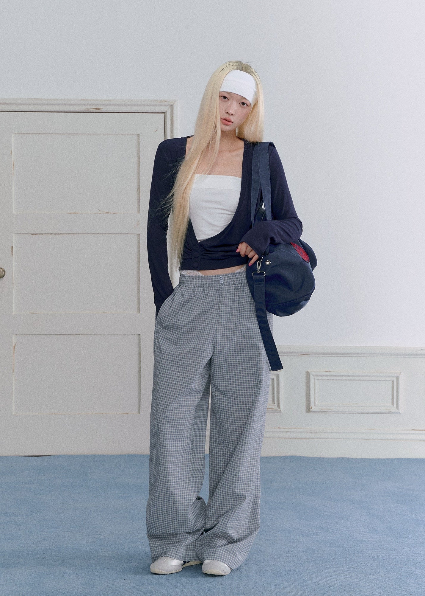 Model wearing gray plaid wide-leg pants with vintage lace waist detailing