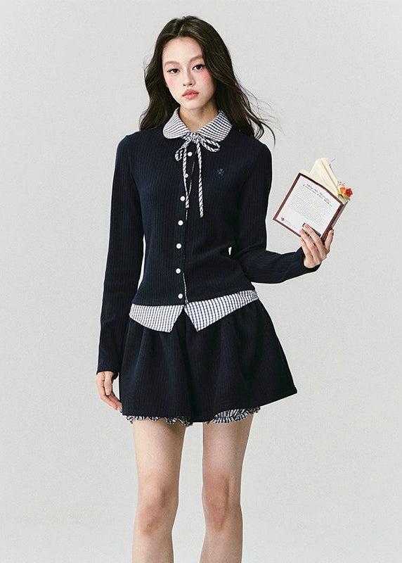 The Moon Academy Knit Set reimagines classic school-girl charm through Fragileheart’s lens of quiet luxury. Featuring a fitted knit blouse with a gingham collar and bow detail, paired with a matching pleated skirt, this ensemble balances intellectual poise and youthful softness. Perfect for autumn transitions and city walks that whisper elegance, not effort.