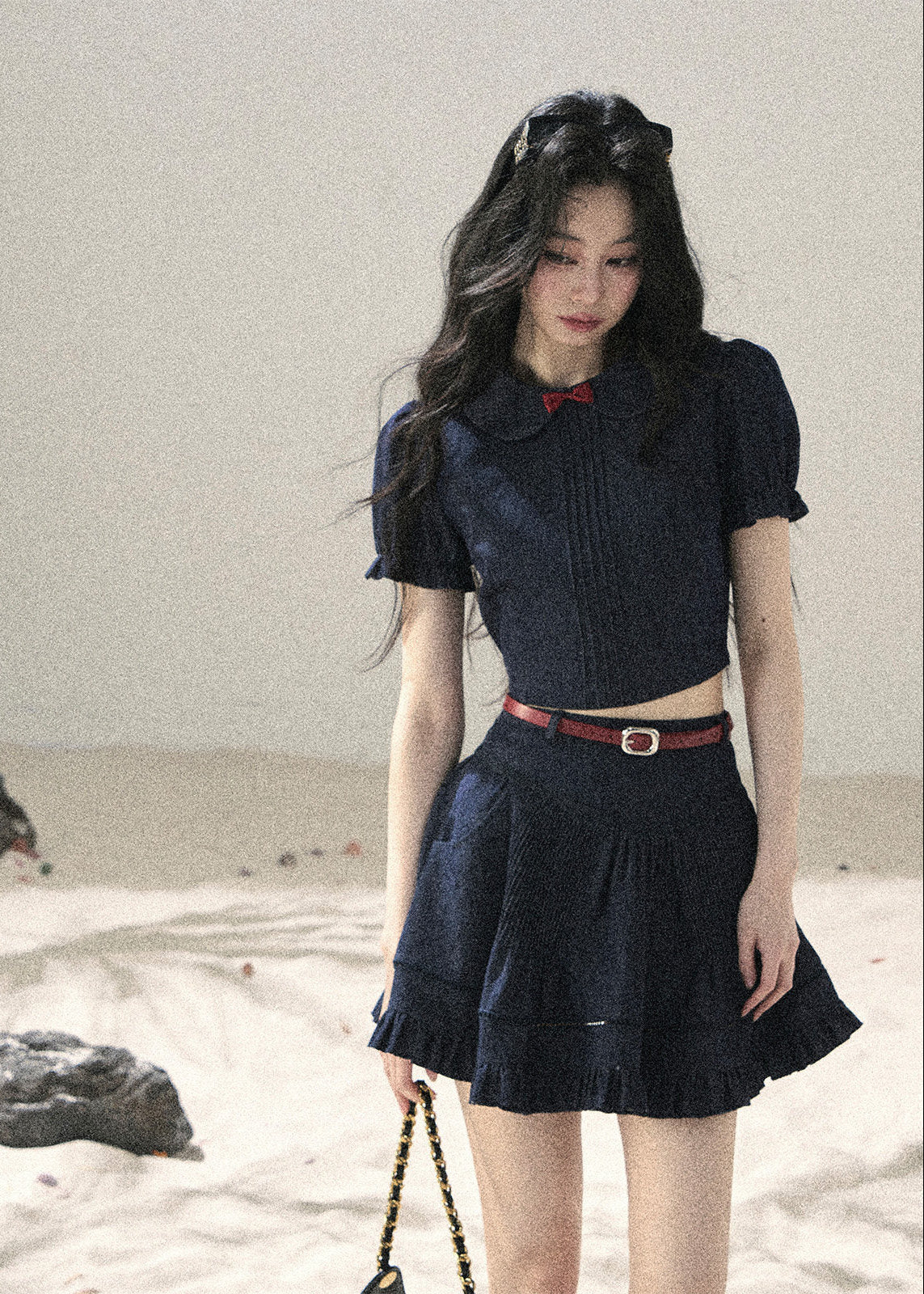 Short-sleeve crop top styled with pleated mini skirt