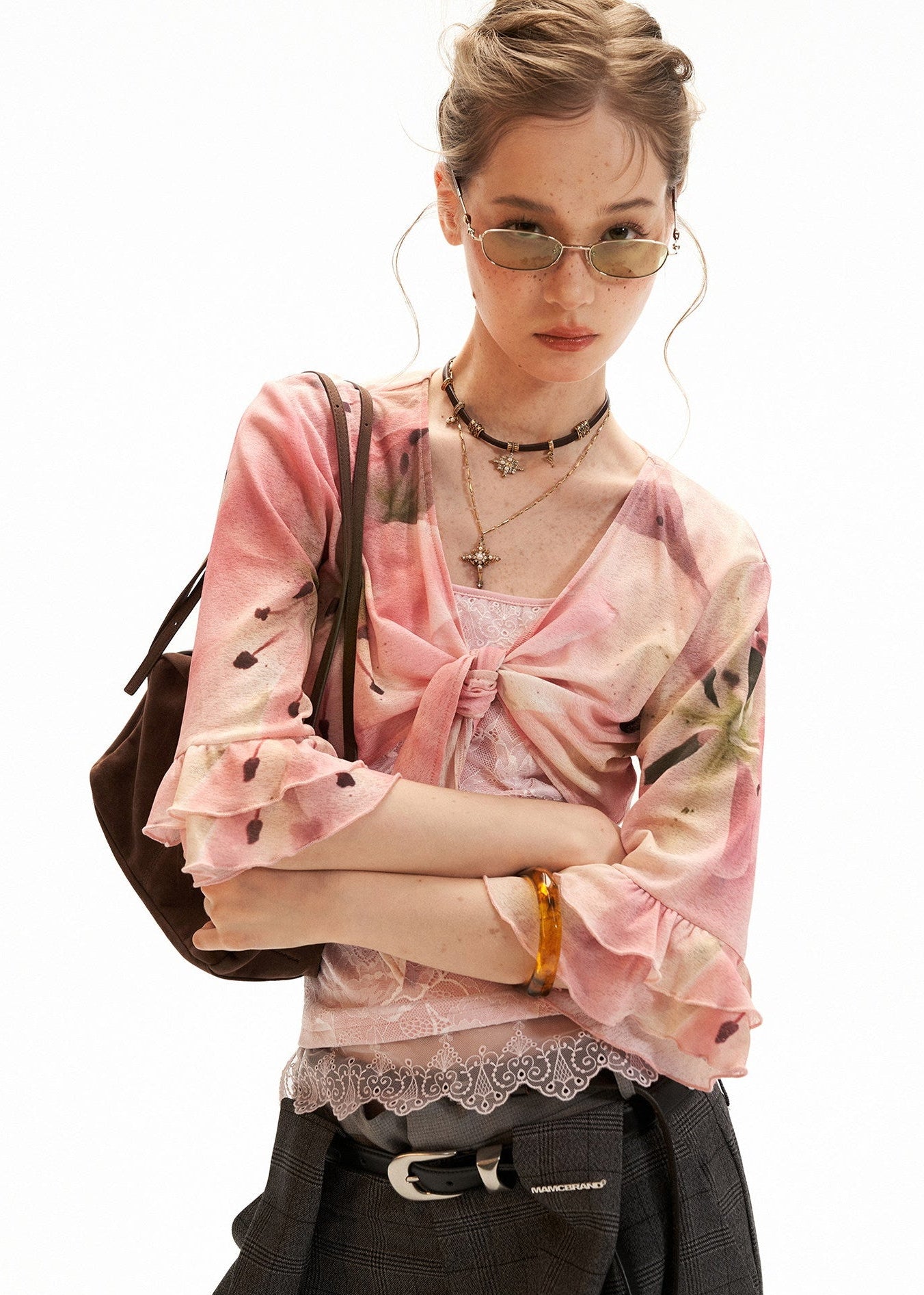 Sheer floral cardigan layered over a lace-trim cami