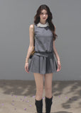 Model wearing a gray sleeveless mini dress with a white contrast collar