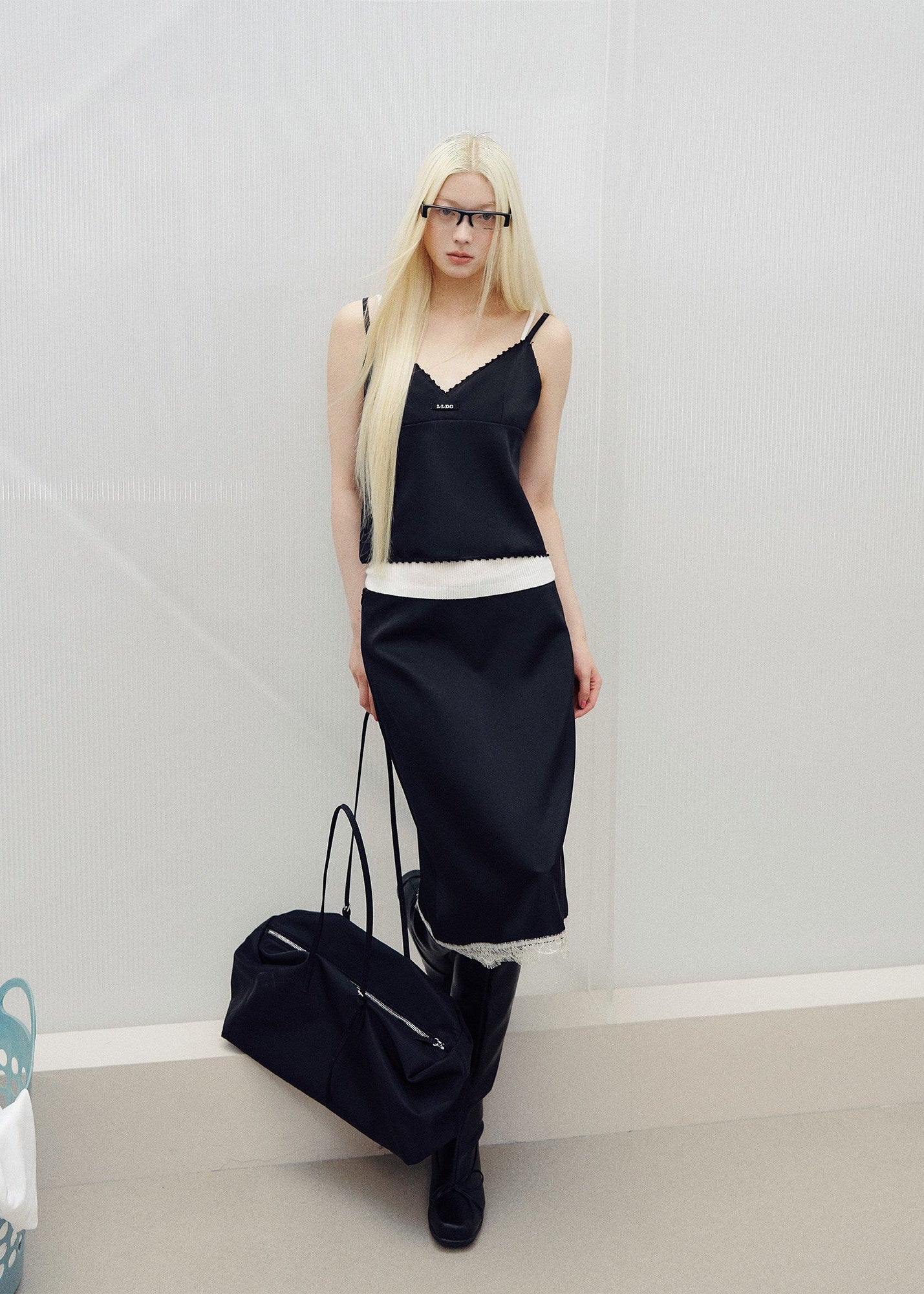 Models wearing pink and black lace-trim camisole and midi skirt sets
