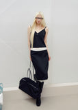 Models wearing pink and black lace-trim camisole and midi skirt sets