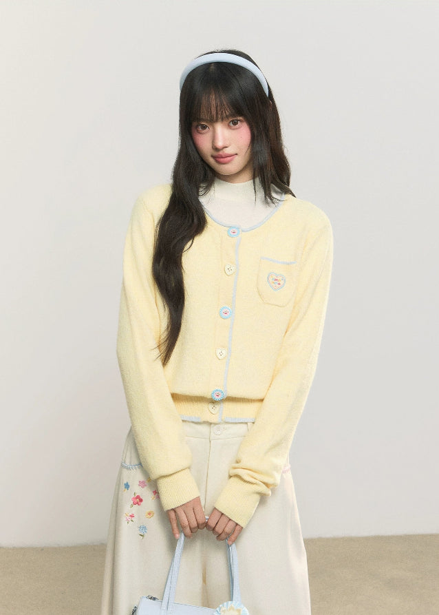 pastel cardigan, heart embroidery knit, contrast trim sweater, Korean girly fashion, AW soft knitwear, umoumo aesthetic cardigan, sweet colored yarn knit, pastel blue cardigan, cute heart badge knit, feminine Korean outfit, loose cozy knit jacket, pink button cardigan, soft winter knit, Fragileheart aesthetic, girly pastel style, cute short cardigan, warm autumn winter knit top, Korean cute girl sweater