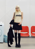 Sleeveless striped knit polo top styled with dark bottoms outdoors