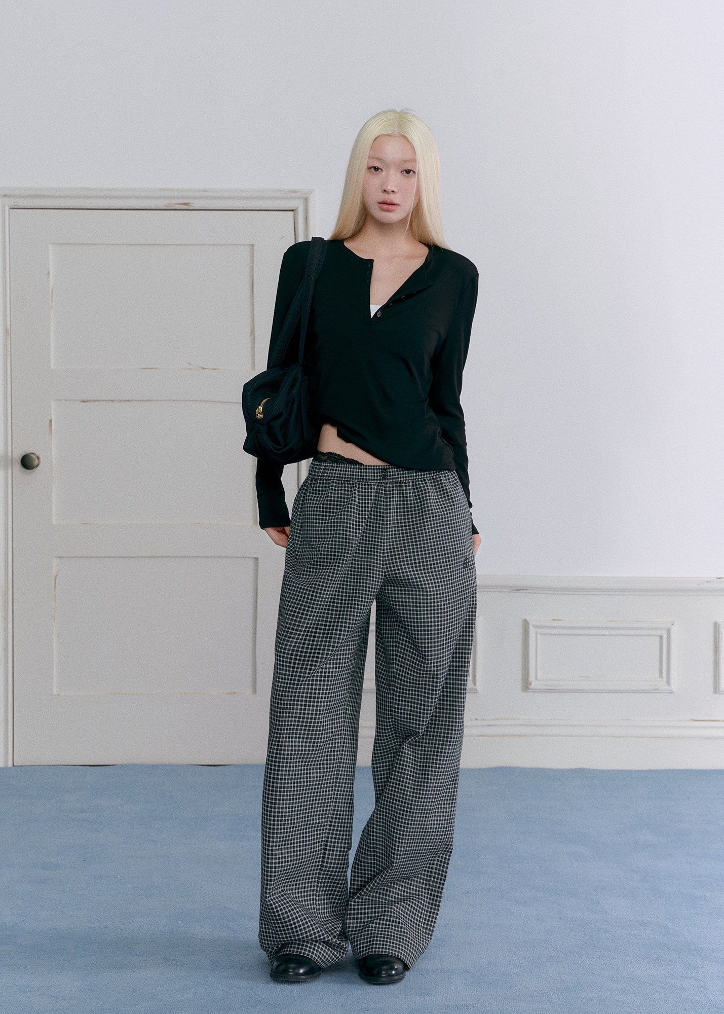 Relaxed black wool-blend Henley shirt styled with plaid pants