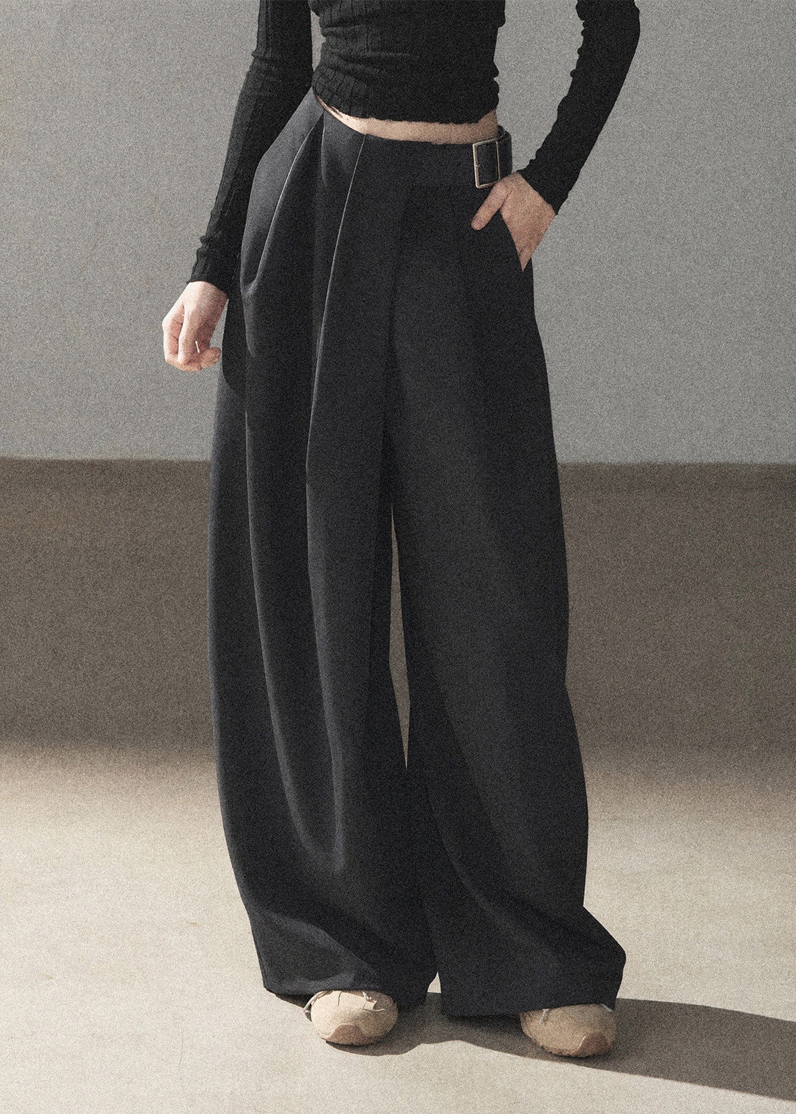 Model wearing taupe loose wide-leg pants