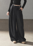 Model wearing taupe loose wide-leg pants