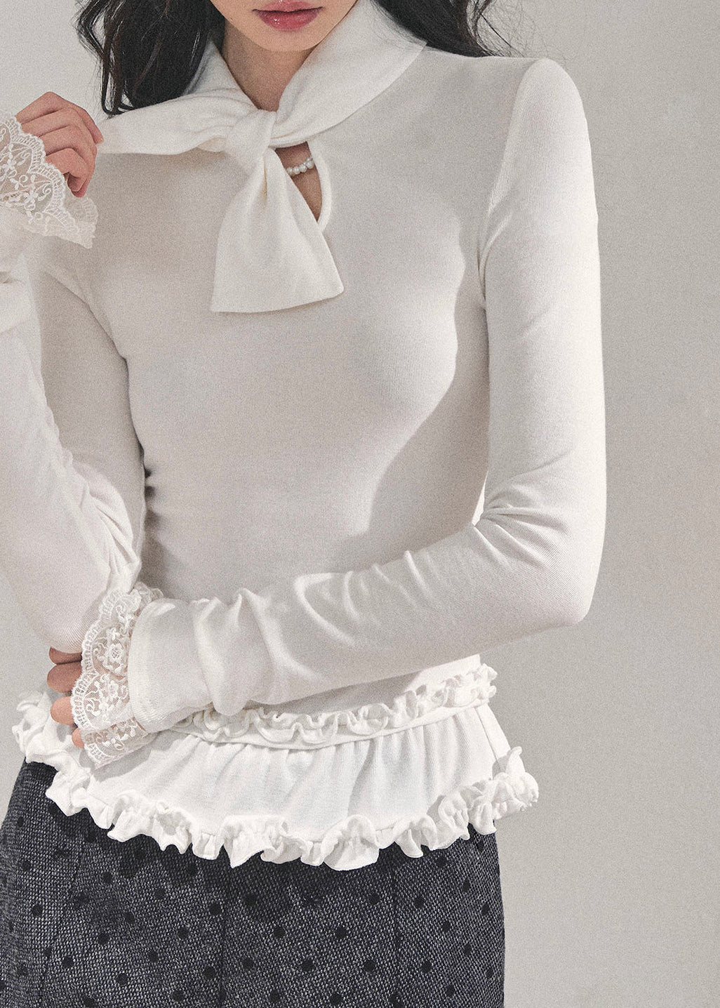 AOMALM top, Korean style knit top, fungus ruffle hem, bow lace T-shirt, winter feminine top, lace cuff long sleeve, soft knit blouse, aesthetic Korean fashion, winter layering top, slim fit tee women, elegant knitwear, ruffle lace shirt, cute winter tops, Korean girl outfit, soft girl aesthetic top, feminine long sleeve tee, winter fashion 2025, trending Korean tops, lace trim sweater top, chic bow neck shirt, romantic knit top.
