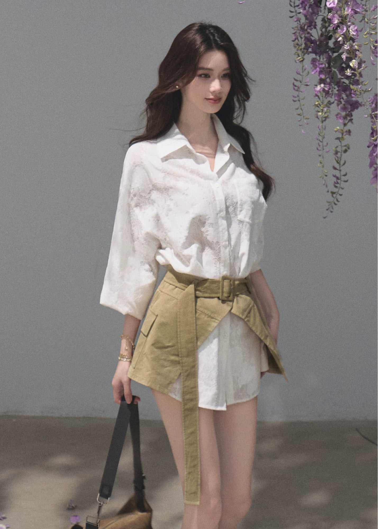 Model wearing a white shirt dress with a natural lace-up waist cincher