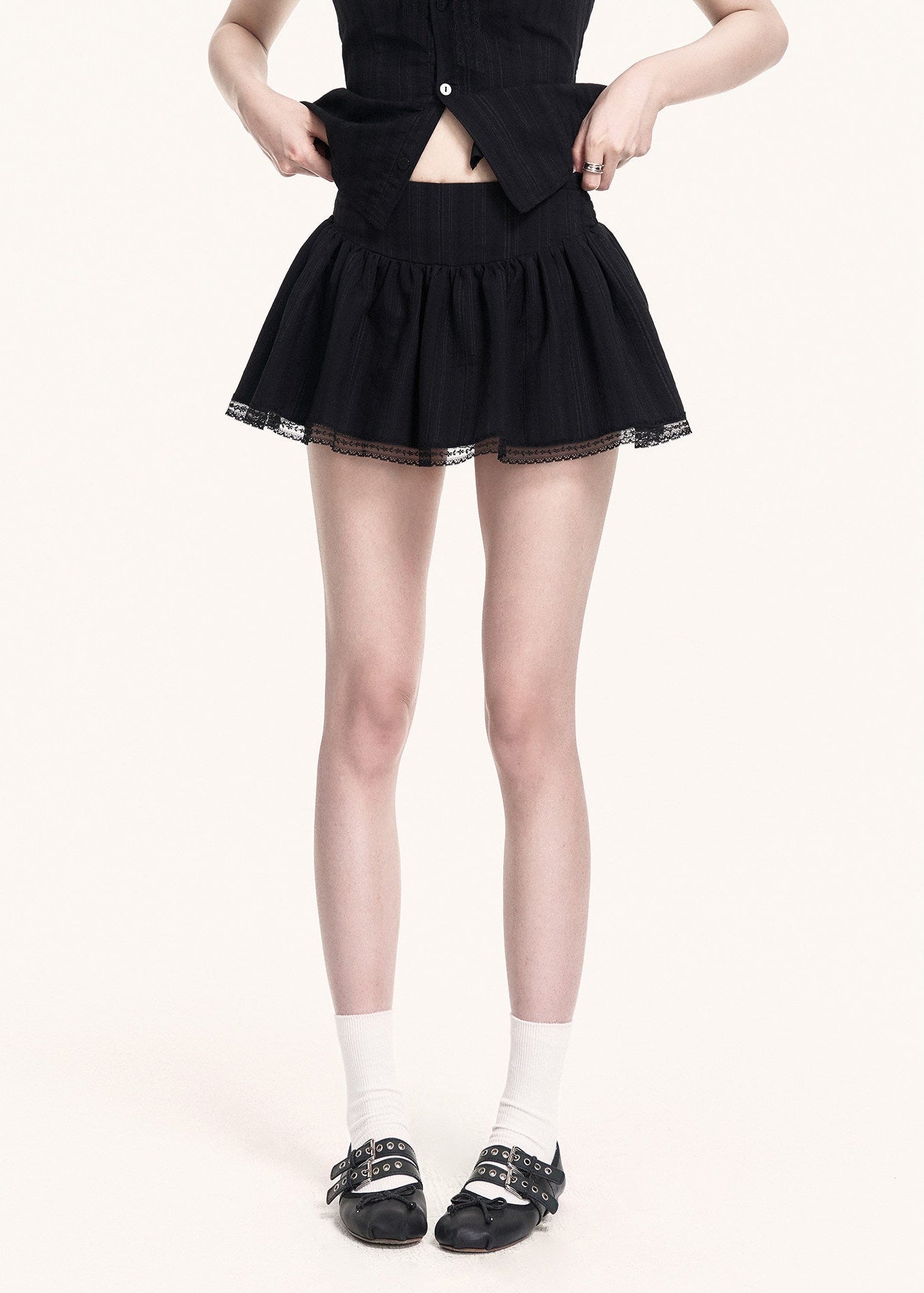 Edgy black two-piece outfit with flared mini skirt