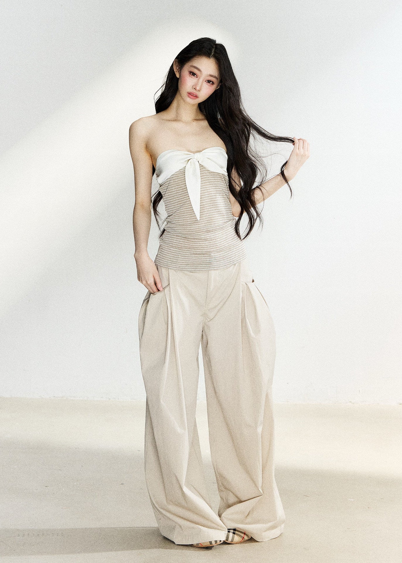 Beige high-waisted wide-leg trousers with side pleats