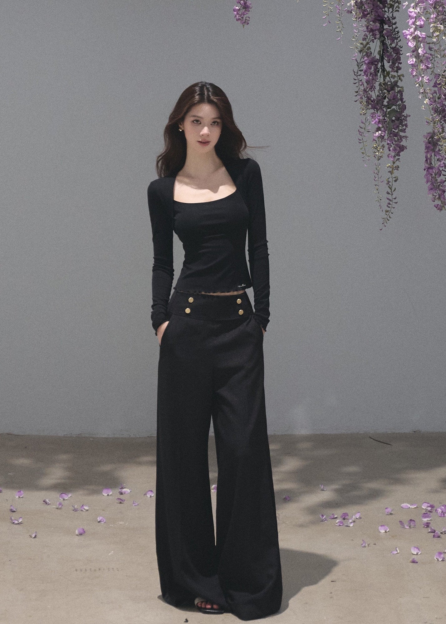 Black fitted long-sleeve top with a softly squared neckline