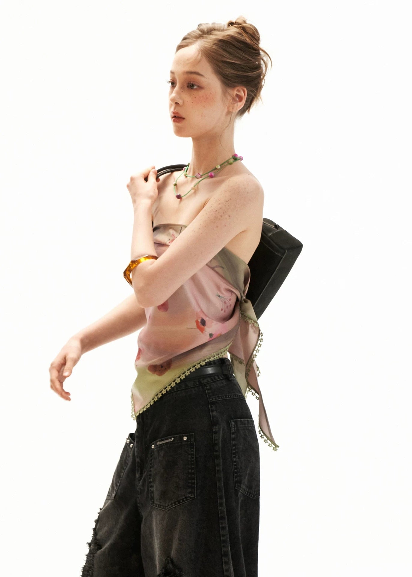 Front view of a printed strapless scarf-hem top