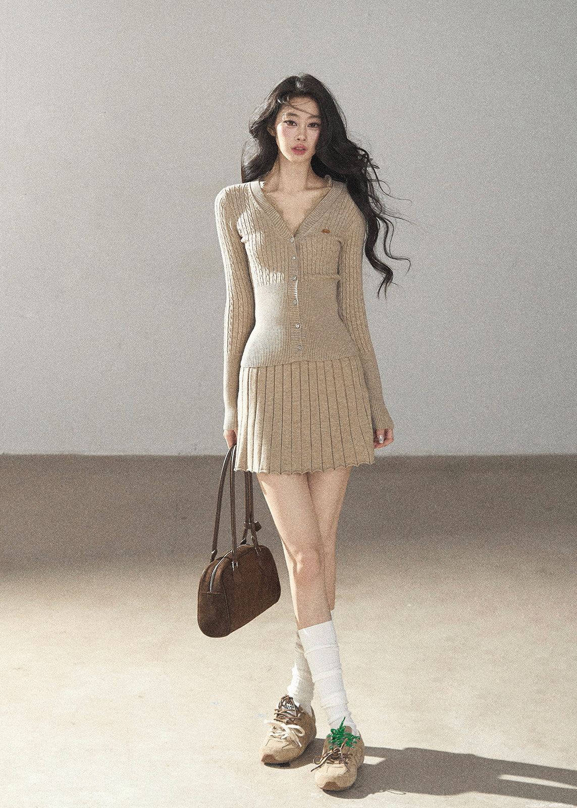 Women's fitted V-neck button cardigan with matching pleated knit skirt