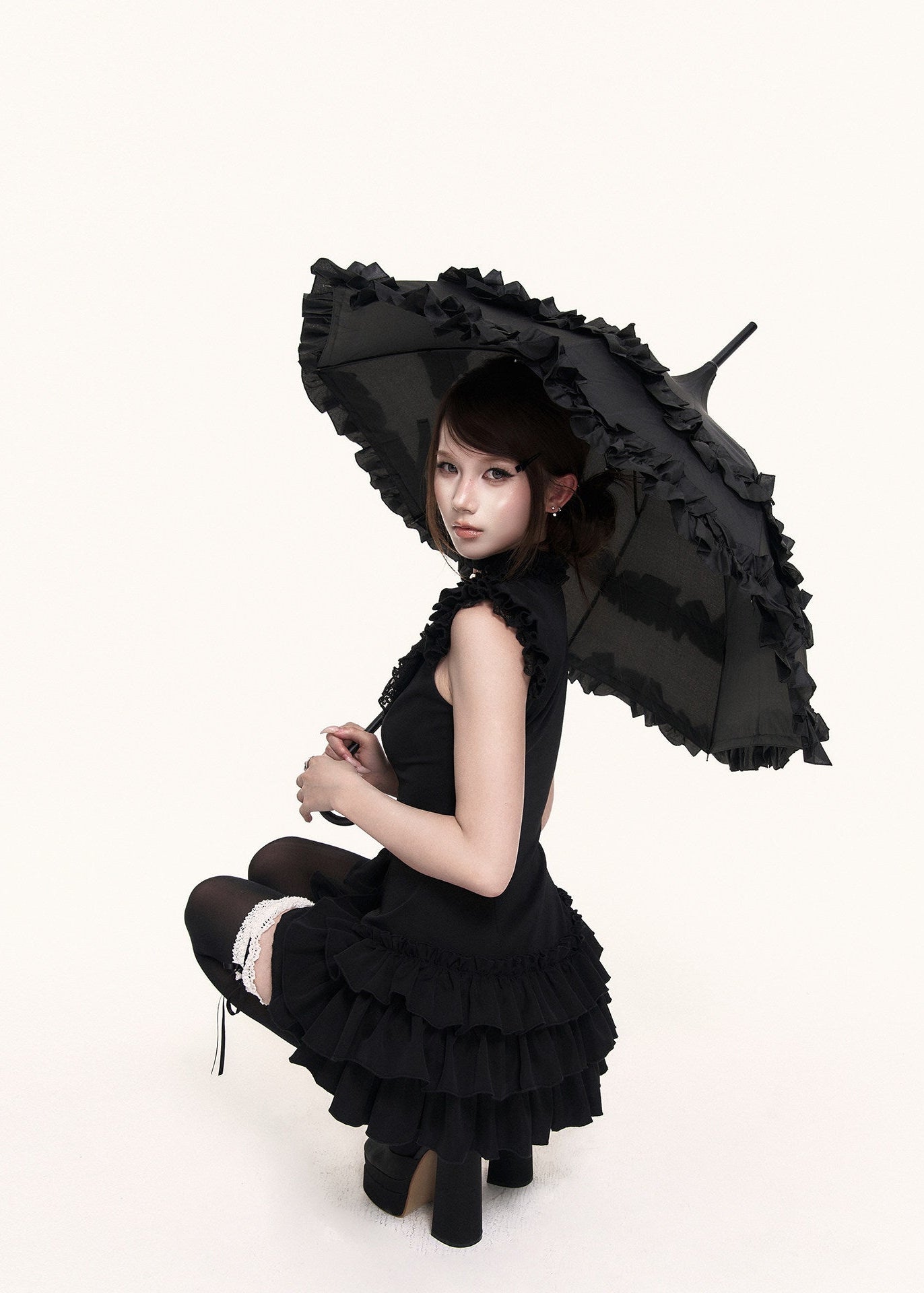 Gothic-inspired black mini dress with tiered hem