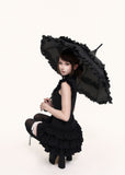 Gothic-inspired black mini dress with tiered hem