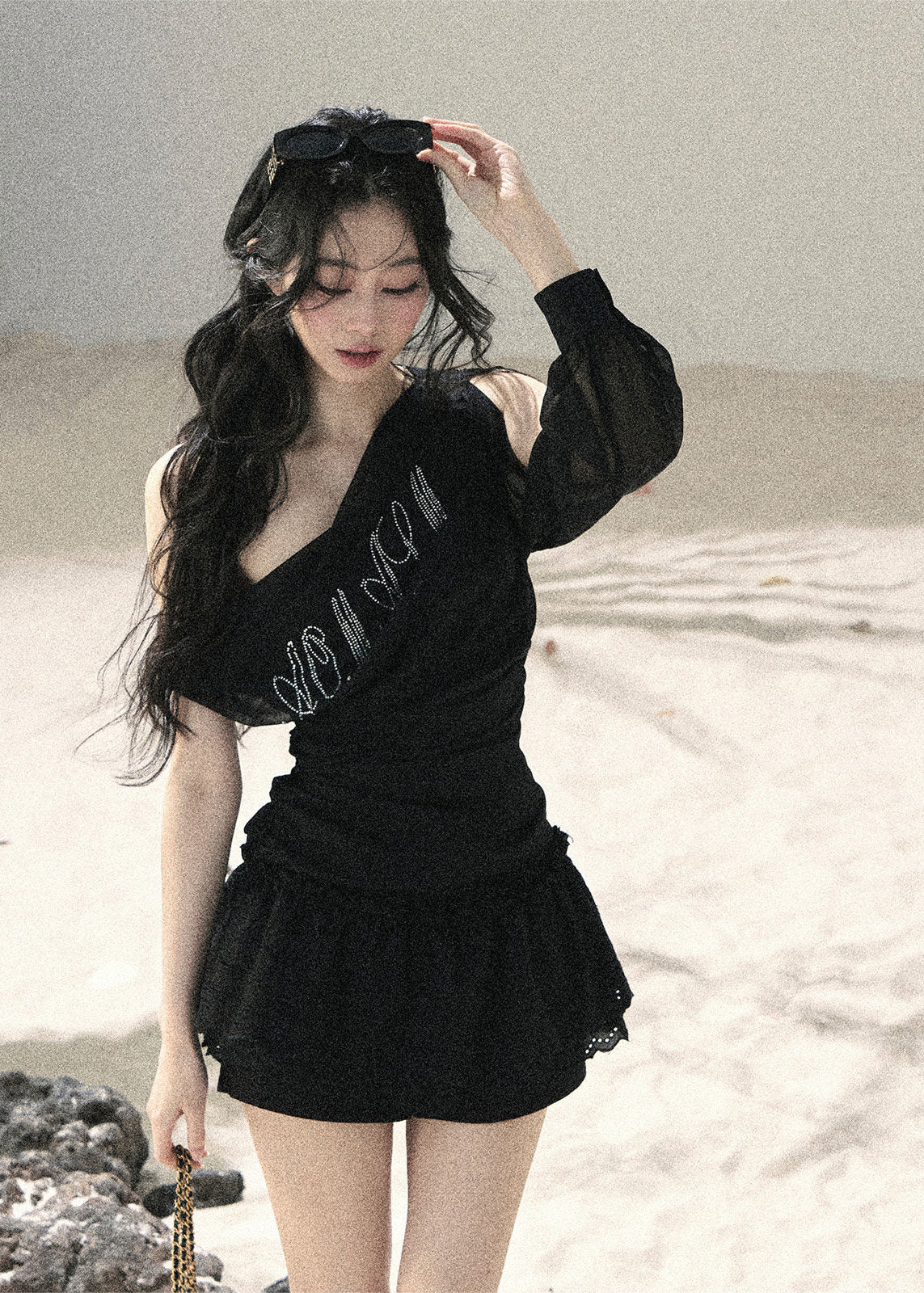 Black off-shoulder mesh top with ruched fit and sheer long sleeve