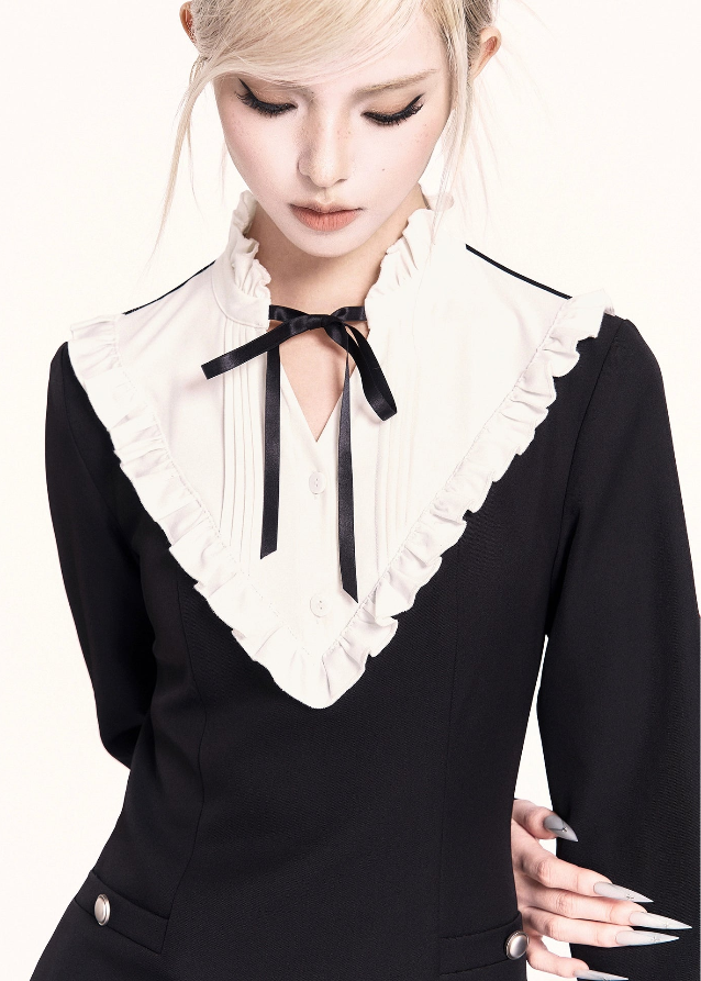 A refined Korean-style holiday dress set featuring a lace-trimmed bow collar mini dress paired with a luxurious woolen cape. The silhouette is soft yet slimming, blending sweet elegance with VOCK’s signature modern edge. Perfect for winter dates, parties, and seasonal photos.