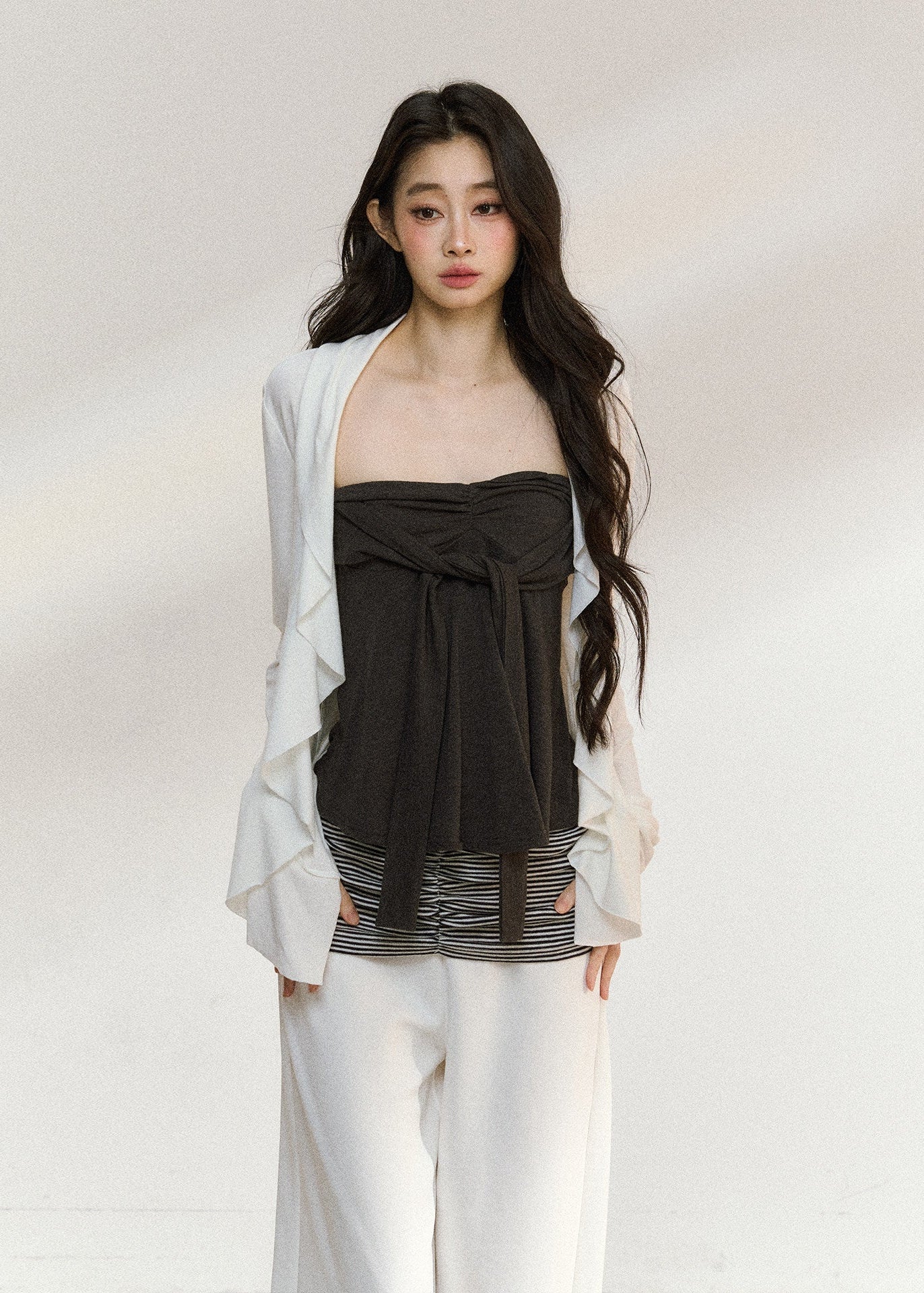 White draped cardigan with a charcoal gathered camisole