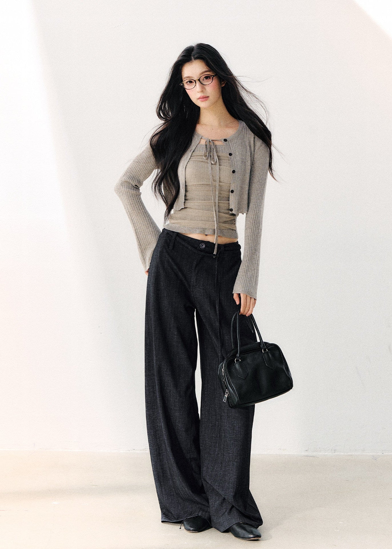 Dark indigo pleated wide-leg trousers with a foldover waist