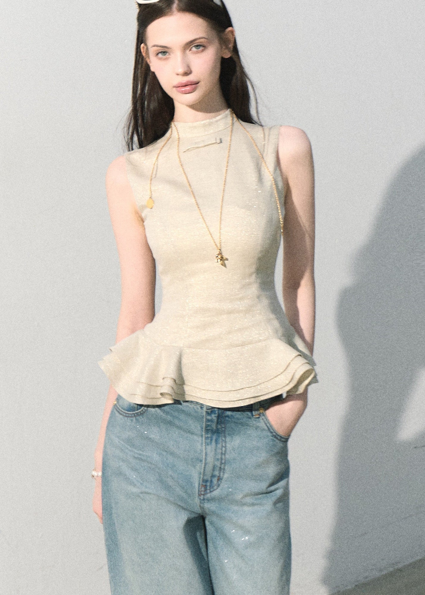 Fitted high-neck top with a flared ruffle waist