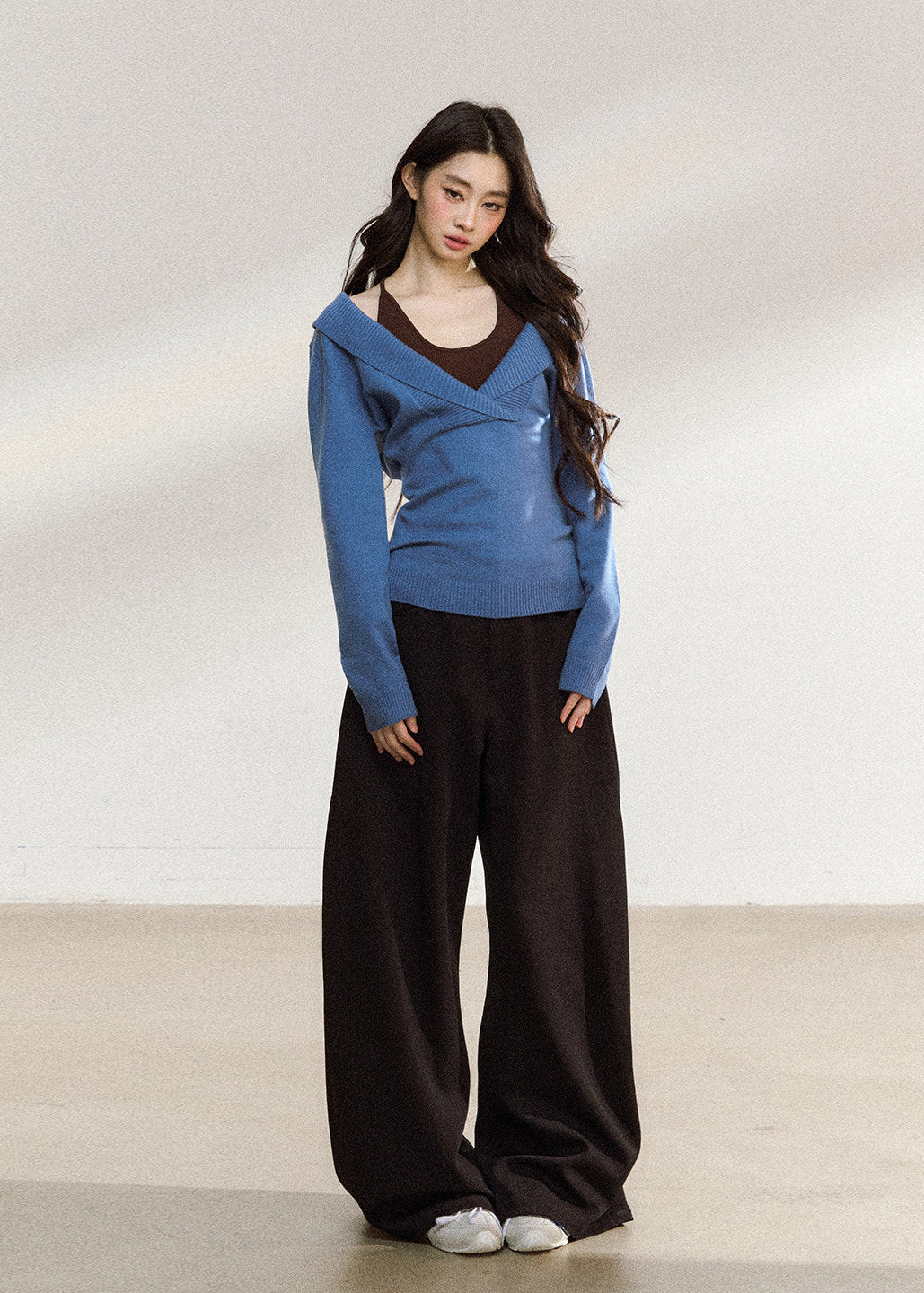 Women’s blue wrap-front sweater with relaxed shoulders