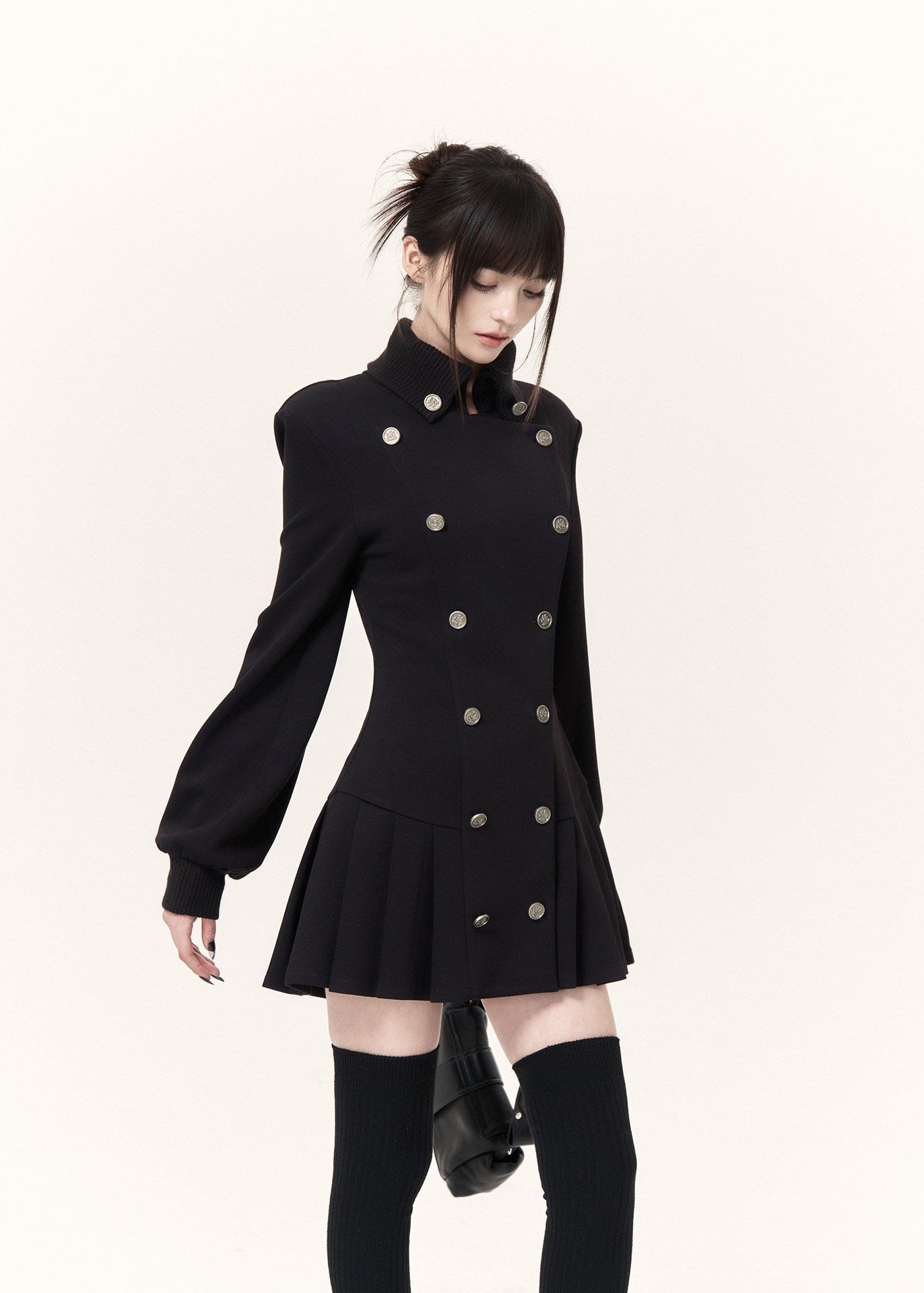 Black Napoleon-style mini dress with metallic buttons and flared pleated skirt