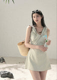 Sage green V-neck mini dress with a softly defined waist