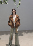 Faded green wide-leg jeans with distressed knee openings