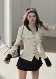 Ivory contrast trim waffle knit cardigan with black pleated mini skirt