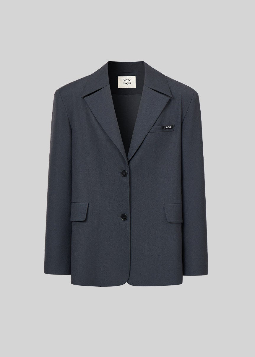 Single-breasted charcoal tailored jacket displayed against a light gray background