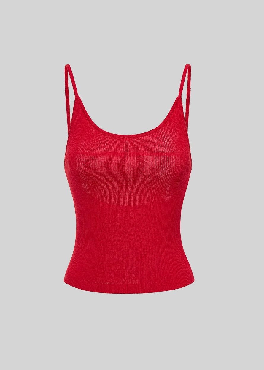 1. Model wearing a fitted red knit camisole with a low neckline and a navy cap