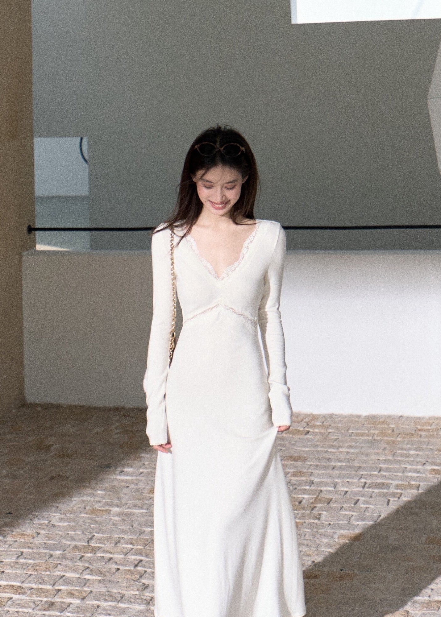 Elegant ivory long sleeve maxi dress with flowing flared skirt