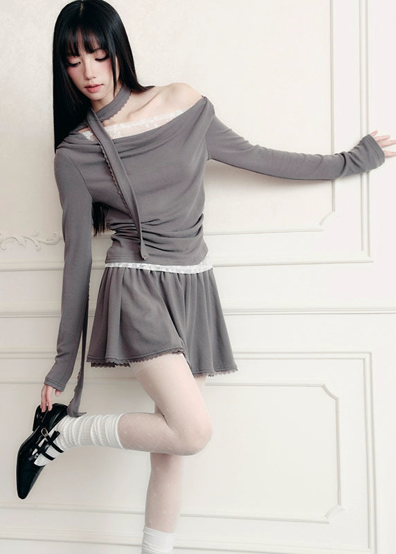 The Migratory Lace Sonata Set drapes the body in Fragileheart’s signature melancholy elegance. A soft ashen knit wraps asymmetrically over lace, revealing just enough fragility beneath structure. Paired with a flowing skirt trimmed in translucent lace, it moves like twilight — graceful, introspective, and quietly magnetic.