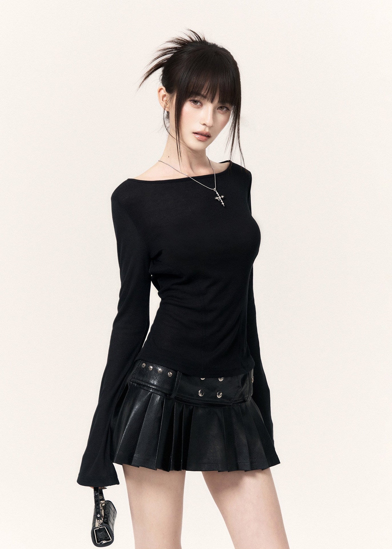 White long-sleeve top with an angel wing back print styled with a black mini skirt and cap